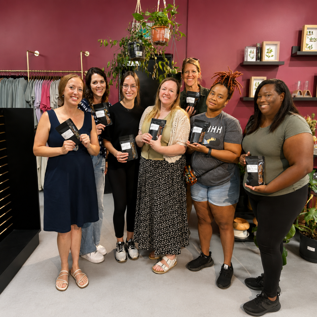 group of women holding custom tea blends at the blend bar berry kissed bliss